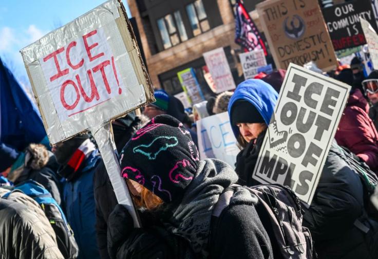 Demonstrators holding "ICE OUT!" and "ICE OUT OF MPLS" participate in a rally and march during an "ICE Out” day of protest on January 23, 2026 in Minneapolis, Minnesota in a photagraph by Brandon Bell for Getty.